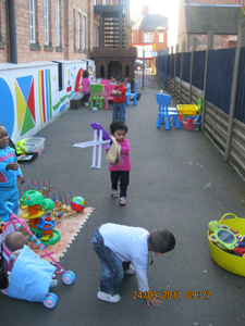 Pre-school children playing outside at Early Learners' Nursery School, Leicester